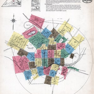 May include: A vintage map of Staunton, Virginia, showing the city's layout with numbered districts. The map is in a circular format with a compass rose in the top left corner. The map is dated November 1921.