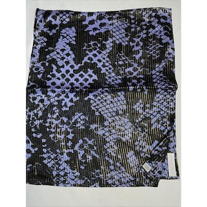 May include: A rectangular scarf featuring a black and light purple snakeskin pattern with vertical metallic gold pinstripes throughout the fabric. The scarf has a pleated texture and includes a small white fabric label in the corner with text.