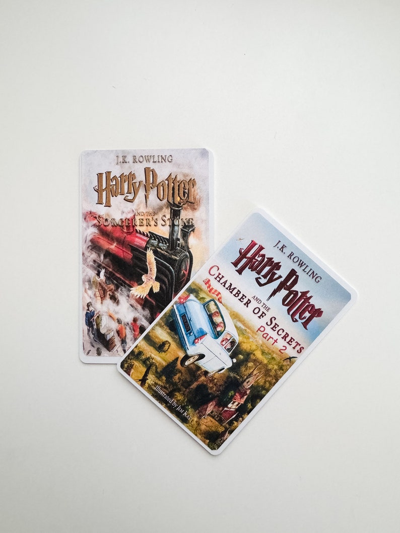 May include: Two paperback books featuring the Harry Potter series by J.K. Rowling. The first book is "Harry Potter and the Philosopher's Stone" and the second book is "Harry Potter and the Chamber of Secrets, Part 2".