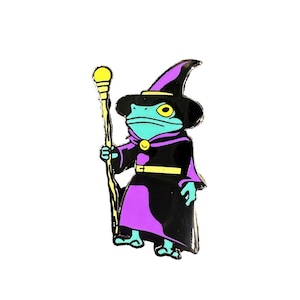 May include: A blue frog wearing a black and purple wizard costume with a yellow pointed hat and holding a yellow staff.