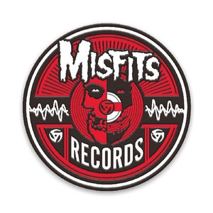 May include: A black and red circular logo with the text "Misfits Records" in white. The logo features a skull with a record player in the eye sockets.