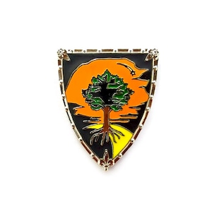 May include: A shield-shaped enamel pin with a tree design. The pin has a black border with a silver trim. The tree has a green crown, brown trunk, and yellow roots. The background is orange and black.
