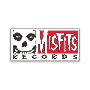 May include: Black and white skull with the text "Misfits Records" in white letters on a red background.