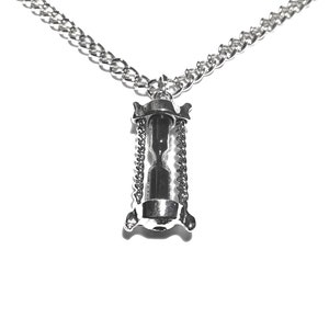 May include: A silver chain necklace with an hourglass pendant. The hourglass is suspended from the chain by two smaller chains.