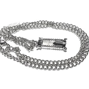 May include: A silver chain necklace with a silver hourglass pendant. The hourglass is filled with sand and has a clear glass body.