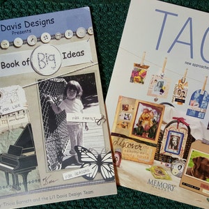 May include: Two craft books with colorful covers. The book on the left is titled "The Li'l Book of Big Ideas" and features a piano, a butterfly, and a child. The book on the right is titled "Tags Reinvented" and features a variety of scrapbook tags.