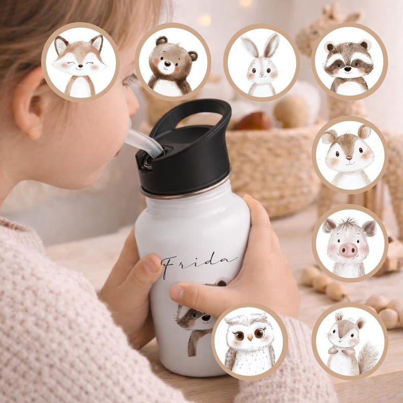 May include: White water bottle with a black lid and a straw. The bottle is decorated with a raccoon illustration and the name "Frida". Additional circular illustrations of woodland animals surround the bottle.