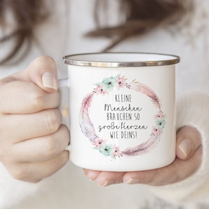 Puede incluir: Taza de esmalte blanco con un dise&ntilde;o de corona floral y el texto "Kleine Menschen brauchen so gro&szlig;e Herzen wie Deins!"