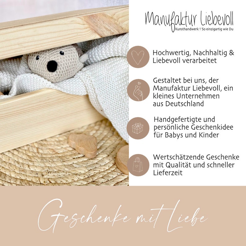 May include: A wooden box with a white knitted blanket and a crocheted stuffed animal inside. The box is sitting on a woven mat. The text "Manufaktur Liebevoll" is written in the upper right corner of the image. The text "Geschenke mit Liebe" is written in the lower right corner of the image.