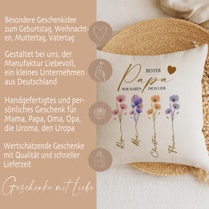 May include: Beige throw pillow with the words "BEST DAD" and "WE LOVE YOU" in script. The pillow features watercolor floral stems with names below. The pillow also has text in German.