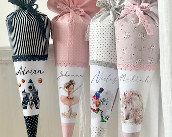 May include: Four personalized school cones with different designs. The cones are made of fabric and have a white base with a colorful design. The cones are decorated with lace and ribbons. The names "Adrian", "Johanna", "Niclas", and "Melijah" are printed on the cones.