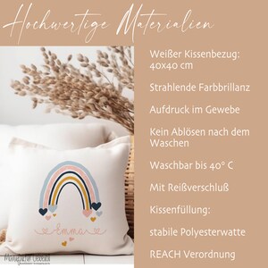 May include: A white pillow with a rainbow and hearts design, personalized with the name "Emma". The pillow is 16 inches by 16 inches and is made with high-quality materials. The pillow is washable and has a zipper closure.