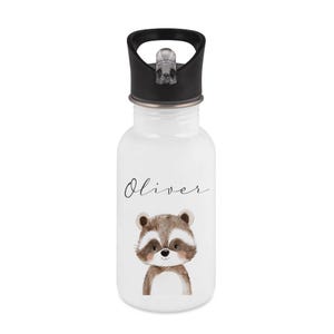 May include: White water bottle with a black lid and a raccoon illustration. The name "Oliver" is written in cursive above the raccoon. The raccoon is brown, white, and tan.