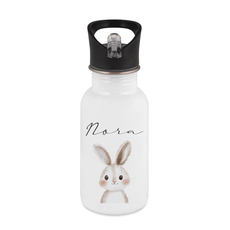 May include: White water bottle with a black lid. The bottle features the name "Nora" in cursive script and a watercolor illustration of a bunny. The bunny has brown ears and a sweet expression.