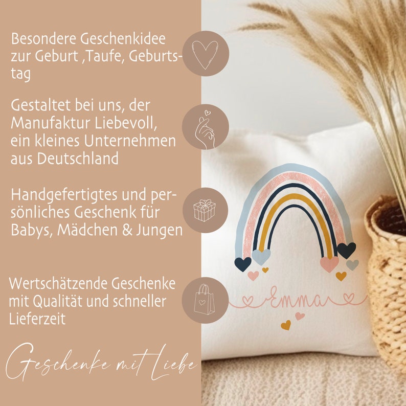 May include: A white pillow with a rainbow design and the name "Emma" written in pink script. The rainbow is made of pink, blue, yellow, and brown stripes. There are pink hearts scattered around the rainbow. The pillow is a personalized gift for a baby.