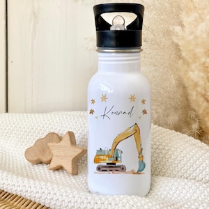 May include: White stainless steel water bottle with a black lid and a yellow excavator design. The bottle has a gold star pattern and the name "Konrad" written on it.
