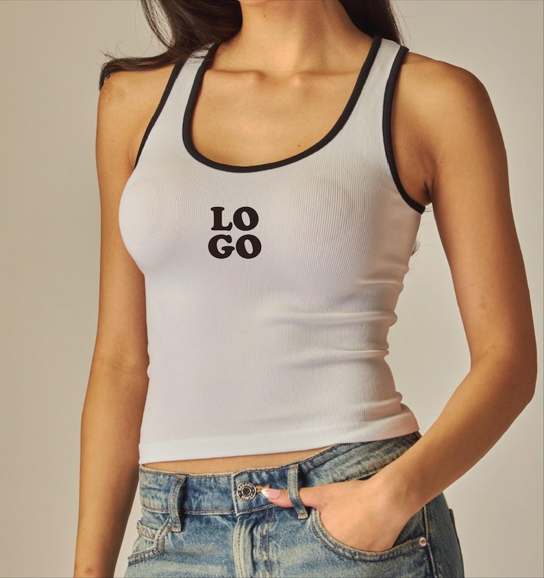 May include: White ribbed tank top with black trim and the word "LOGO" printed in black. The tank top is a racerback style and is paired with blue denim jeans.