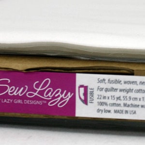 May include: White fusible interfacing fabric roll labeled "Face-It Soft Lightweight Fusible Interfacing" by "Sew Lazy by Lazy Girl Designs" with the product number "SLG103".