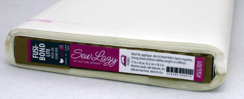 May include: A roll of white fusible bonding fabric labeled "Fusi-Bond Lite Iron-On Adhesive" by Sew Lazy. The label also includes the text "Ideal for applique. Use to bond fabric layers together. Strong bond without adding weight or stiffness. 17 in x 20 yd, 43.2 cm x 18.3 m. Machine wash cold delicate, dry delicate low heat. Made in USA. #SLG101"