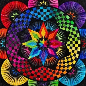 May include: A colorful quilt with a starburst design in the center. The starburst is surrounded by a checkerboard pattern and a ring of colorful sunbursts. The quilt is made with a variety of fabrics, including red, orange, yellow, green, blue, indigo, and violet.