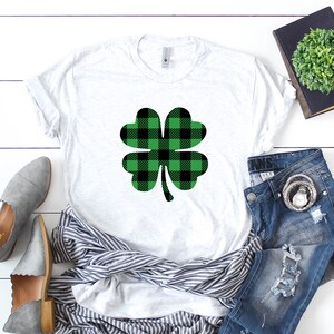 May include: A white t-shirt with a green and black plaid shamrock design.