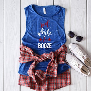 May include: A blue sleeveless shirt with the text "red white & booze" in red and white lettering. The shirt is styled with a red and blue plaid shirt and white sneakers.