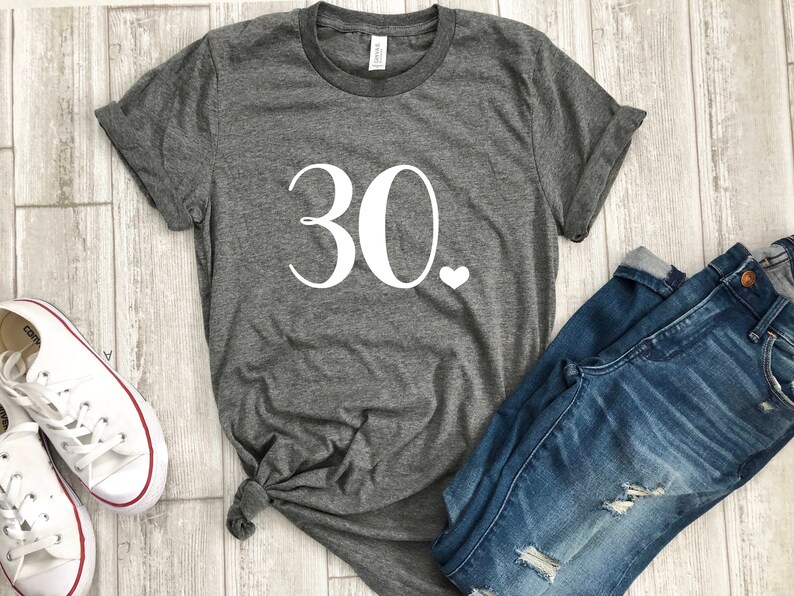 May include: Gray t-shirt with white text that says "30." and a small white heart.