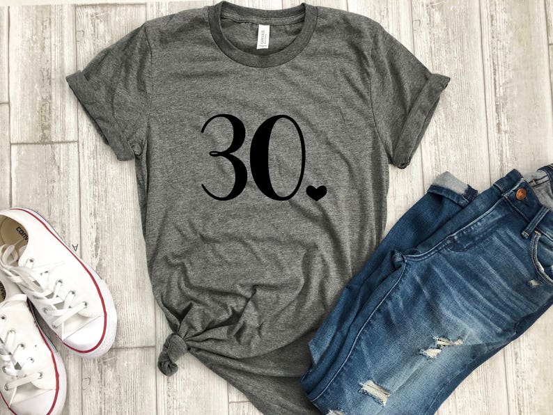 May include: Gray t-shirt with the number 30 and a small heart printed on the front.