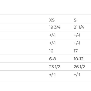 May include: Size chart for a shirt with measurements in inches for XS, S, M, L, and XL sizes. Measurements include body length, chest width, sleeve length, and size in US sizing.