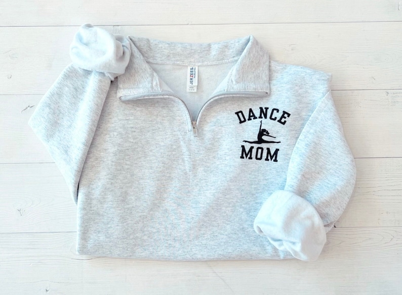 May include: Grey sweatshirt with a black graphic of a dancer and the text "DANCE MOM".