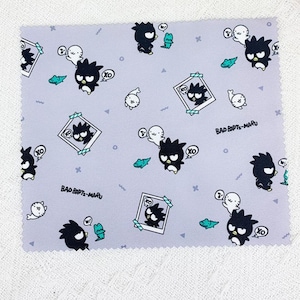 May include: Purple fabric with a repeating pattern of black and white cartoon characters. The characters are wearing hats and have a speech bubble that says "XO". The fabric also has a repeating pattern of small white seals, green lizards, and the text "Bad B*tze-Maru".