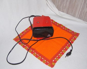 Seventies original electric alarm clock in bright orange