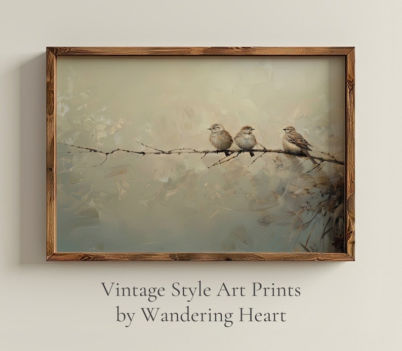 May include: A framed vintage style art print featuring three brown birds perched on a branch against a soft, muted background of blue, green, and white. The birds are facing to the right and are in a row. The print is framed in a rustic brown wood frame. The text below the image reads 'Vintage Style Art Prints by Wandering Heart'.