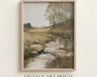 May include: A framed painting of a stream flowing through a forest. The stream is surrounded by green grass and trees. The painting is in a light wood frame.