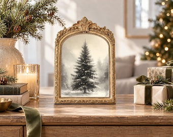 May include: An arched gold ornate picture frame containing a black and white illustration of a single evergreen tree in a snowy landscape. The frame features intricate relief detailing along the edges and a decorative crest at the top centre.