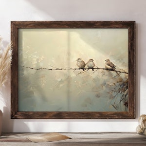 May include: A framed painting of three brown birds perched on a branch. The background is a soft, light blue and white abstract design.