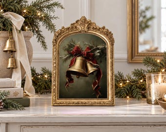 May include: A rectangular gold ornate frame containing a print of two metallic gold bells tied with a deep red ribbon and accented with green pine branches against a dark green background. The frame features intricate scrollwork and floral details.