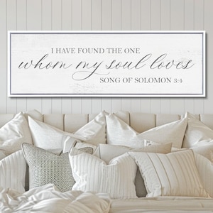 May include: A rectangular wall sign with a white, distressed wood-look background and a thin gray frame. The text reads, "I HAVE FOUND THE ONE whom my soul loves SONG OF SOLOMON 3:4" in a combination of dark gray serif and script fonts.