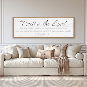 May include: A rectangular wall sign with a light wood frame featuring a white background and black text that reads: Trust in the Lord with all your heart and lean not on your own understanding; in all your ways acknowledge him, and he will make your paths straight. Proverbs 3:5-6.