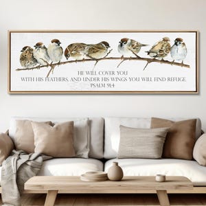 May include: A rectangular wall art piece in a light wood frame featuring a watercolor illustration of seven small brown and white birds perched on a thin branch. Below the birds, the text reads: HE WILL COVER YOU WITH HIS FEATHERS, AND UNDER HIS WINGS YOU WILL FIND REFUGE. PSALM 91:4.