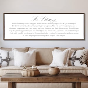 May include: A rectangular wall sign with a dark brown frame featuring the title The Blessing in elegant script followed by a multi-line text passage starting with The Lord bless you and keep you, printed in black on a white background.