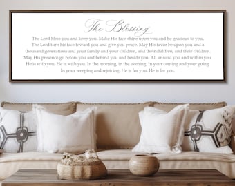 May include: A rectangular wall sign with a dark brown frame featuring the title The Blessing in elegant script followed by a multi-line text passage starting with The Lord bless you and keep you, printed in black on a white background.