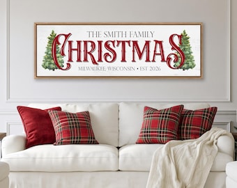 May include: A rectangular wall sign with a white background and a light wood frame. The text reads THE SMITH FAMILY CHRISTMAS, MILWAUKEE, WISCONSIN • EST 2026. The word CHRISTMAS is in large red script, flanked by two green pine tree illustrations.