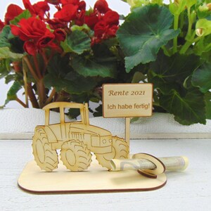 May include: Wooden tractor figurine with a sign that reads "Rente 2021 Ich habe fertig!"  The tractor has a slot for money or a gift card.