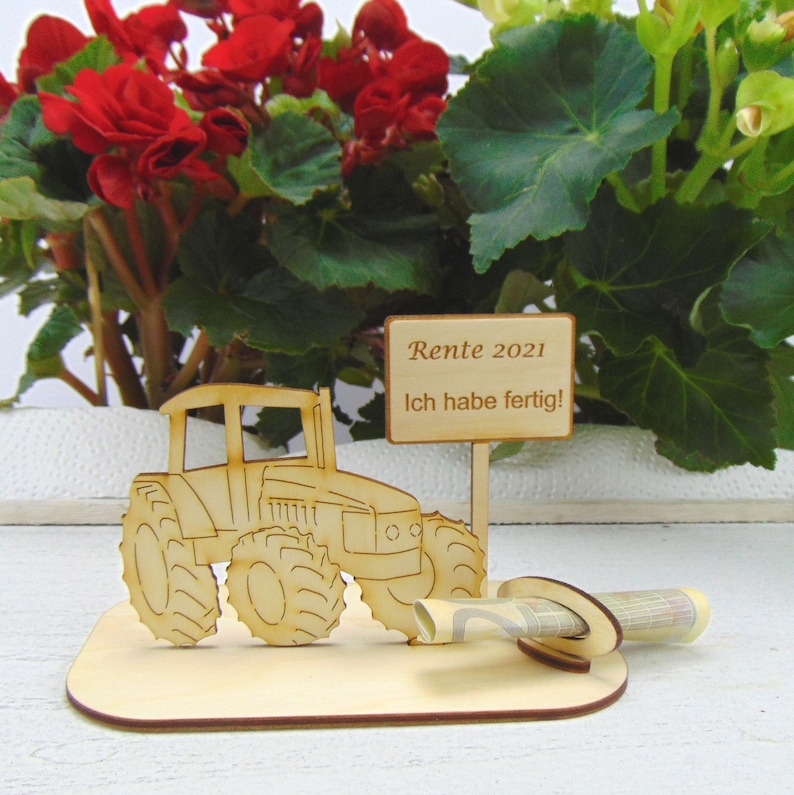 May include: Wooden tractor figurine with a sign that reads "Rente 2021 Ich habe fertig!"  The tractor has a slot for money or a gift card.