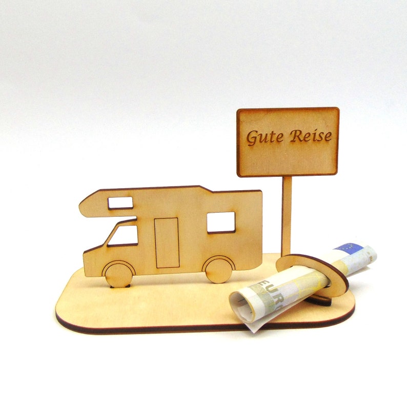 May include: Wooden cutout of a camper van with a sign that reads "Gute Reise" and a slot for a rolled-up bill of money.