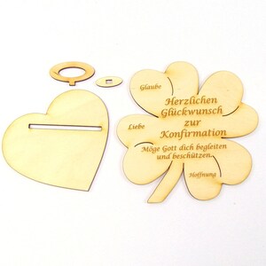 Op de afbeelding: Houten knutselset voor een bevestigingsviering. De set bevat een hartvormige basis, een klavertjevier met de woorden "Glaube, Liebe, Hoffnung" en "Herzlichen Gl&uuml;ckwunsch zur Konfirmation. M&ouml;ge Gott dich begleiten und besch&uuml;tzen."