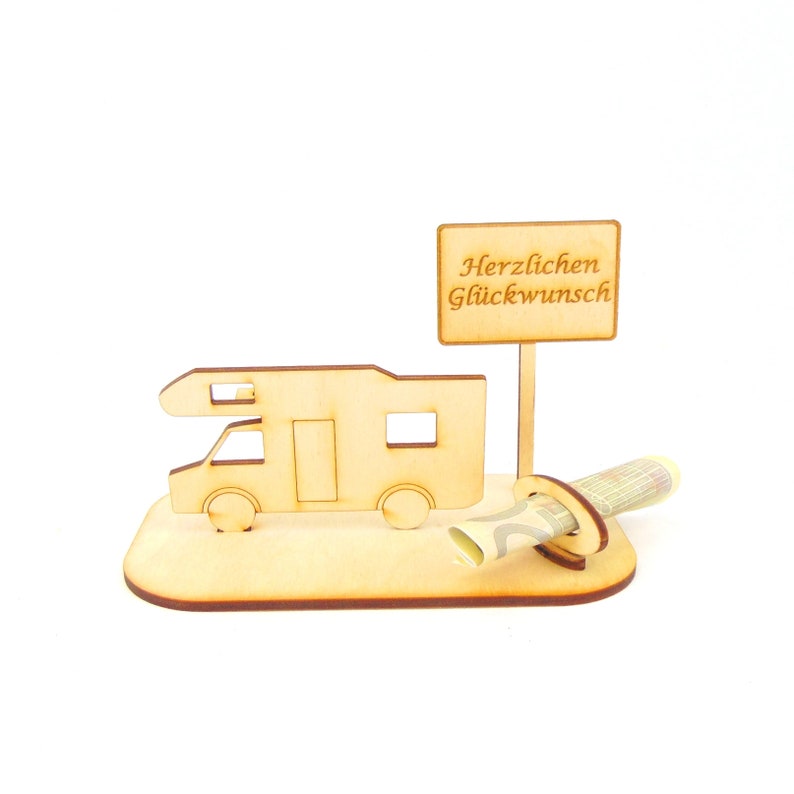 May include: Wooden camper van money holder with a sign that reads "Herzlichen Gl&uuml;ckwunsch" which translates to "Congratulations" in English. The money holder is designed to hold a rolled up bill of money.