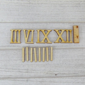 Può includere: Numeri romani in legno per orologio e indicatori delle ore. I numeri includono II, IV, VI, IX, X, XII. Gli indicatori delle ore sono pezzi di legno sottili e rettangolari.