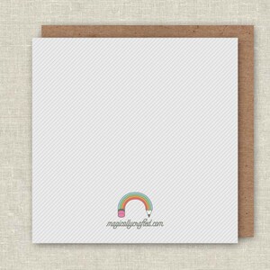 May include: Blank white card with a rainbow and pencil design. The text "magicallycrafted.com" is printed below the design.